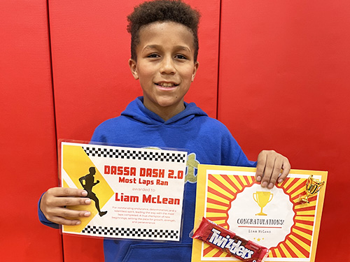Liam holding up his Most Laps Run awards for the Dassa Dash 2.0