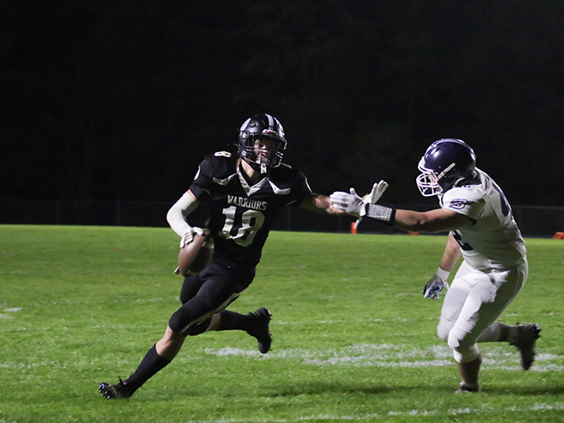 Two football players running on the field
