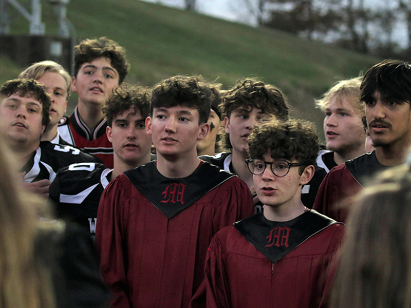 Group of band students watching the game