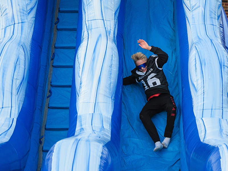 Student on a big blue slide