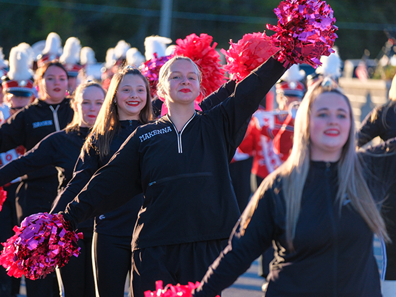 Cheer team holding pom-poms