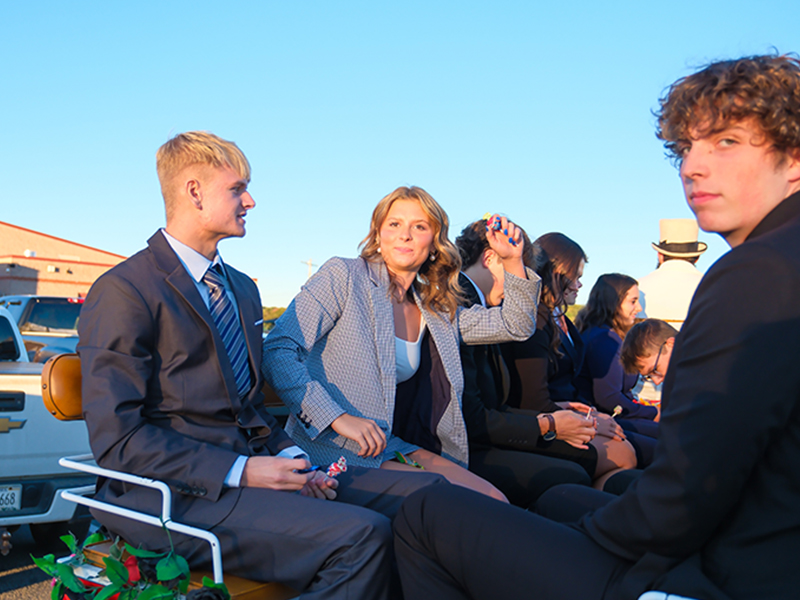 Group of students and adults on a truck float