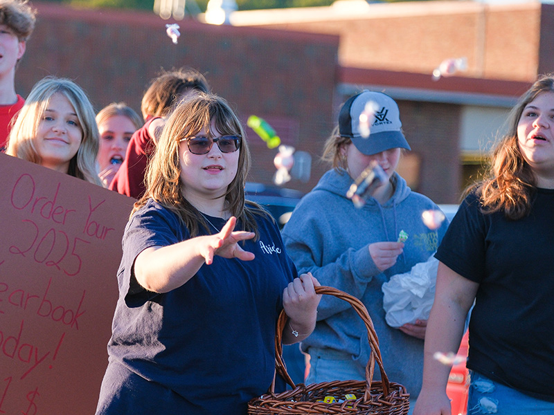 Woman tossing candy from a basket