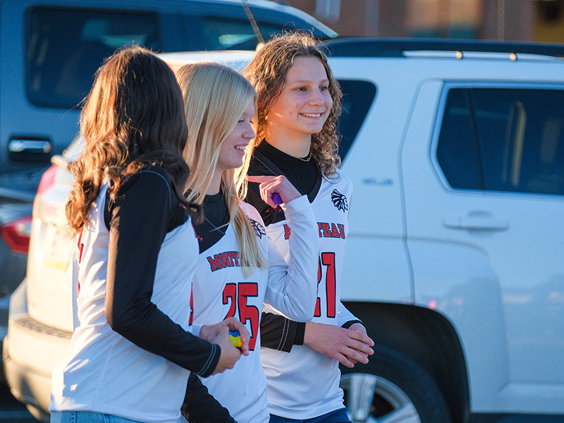 Three happy girls wearing their Moniteau sports jerseys 